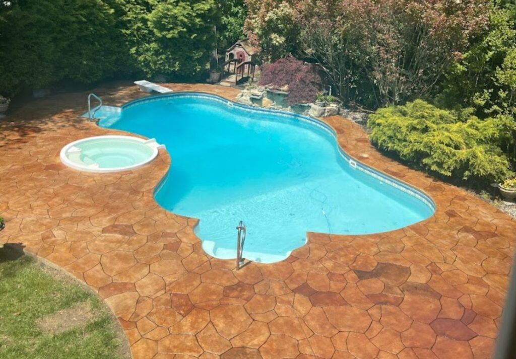 Backyard stamped concrete patio by Jersey Concrete